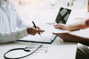 Doctors submit patient records on sticky notes and talk to patients about medications and treatment.